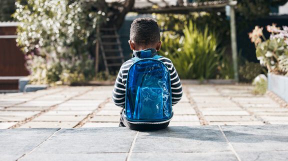 Child sitting outside